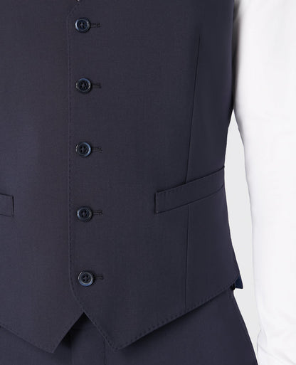 Man wearing a navy Tapered fit wool blend stretch mix and match suit waistcoat