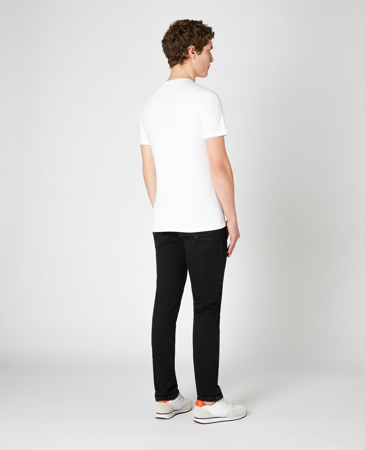 Man wearing a black Slim Fit Cotton Stretch Jeans
