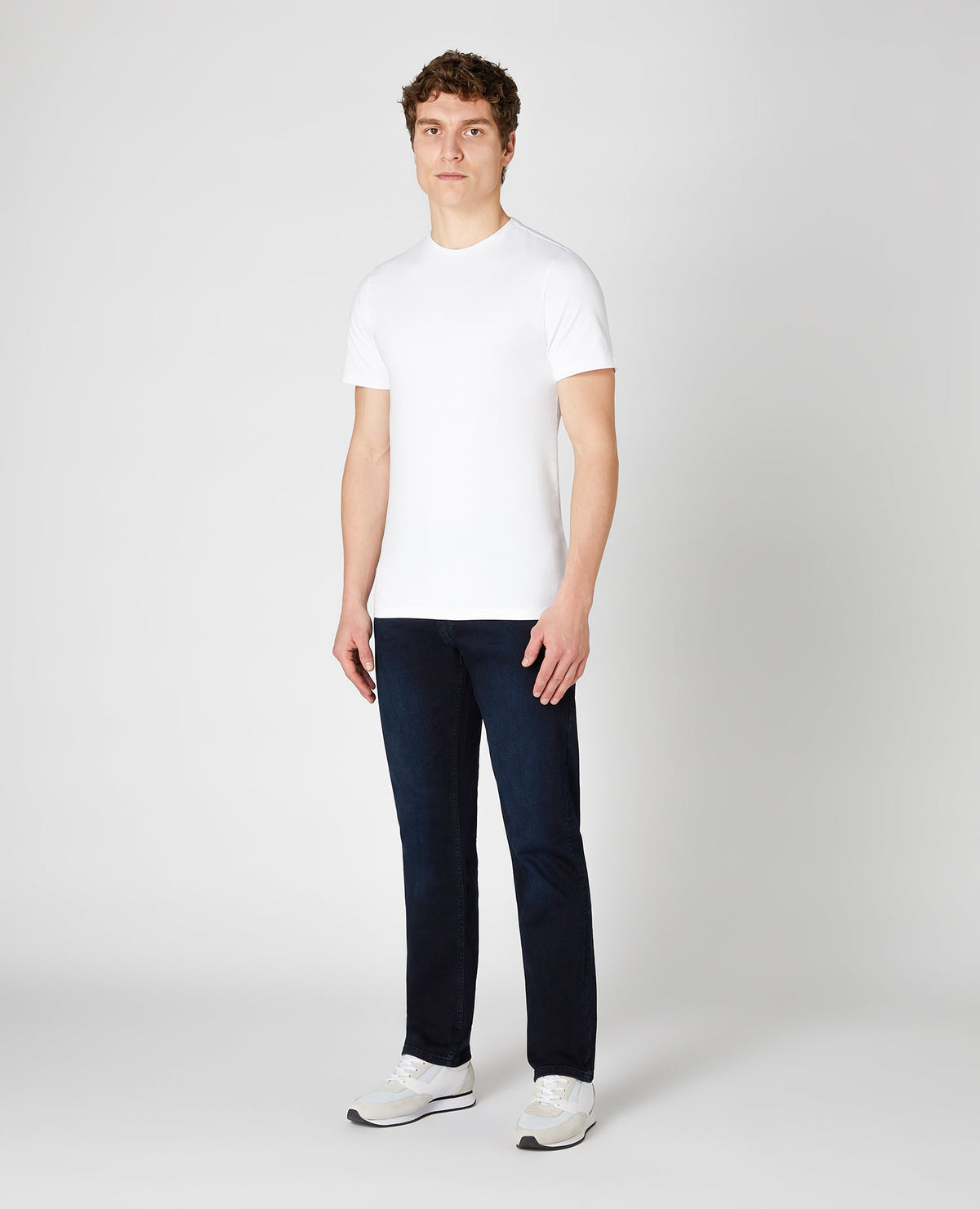 Man wearing a blue Rolston Straight Leg Cotton Stretch Jeans