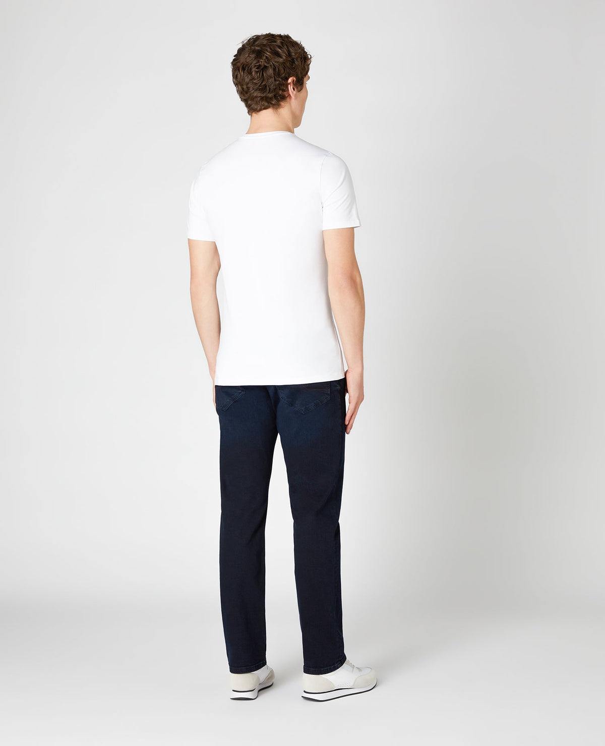 Man wearing a blue Rolston Straight Leg Cotton Stretch Jeans