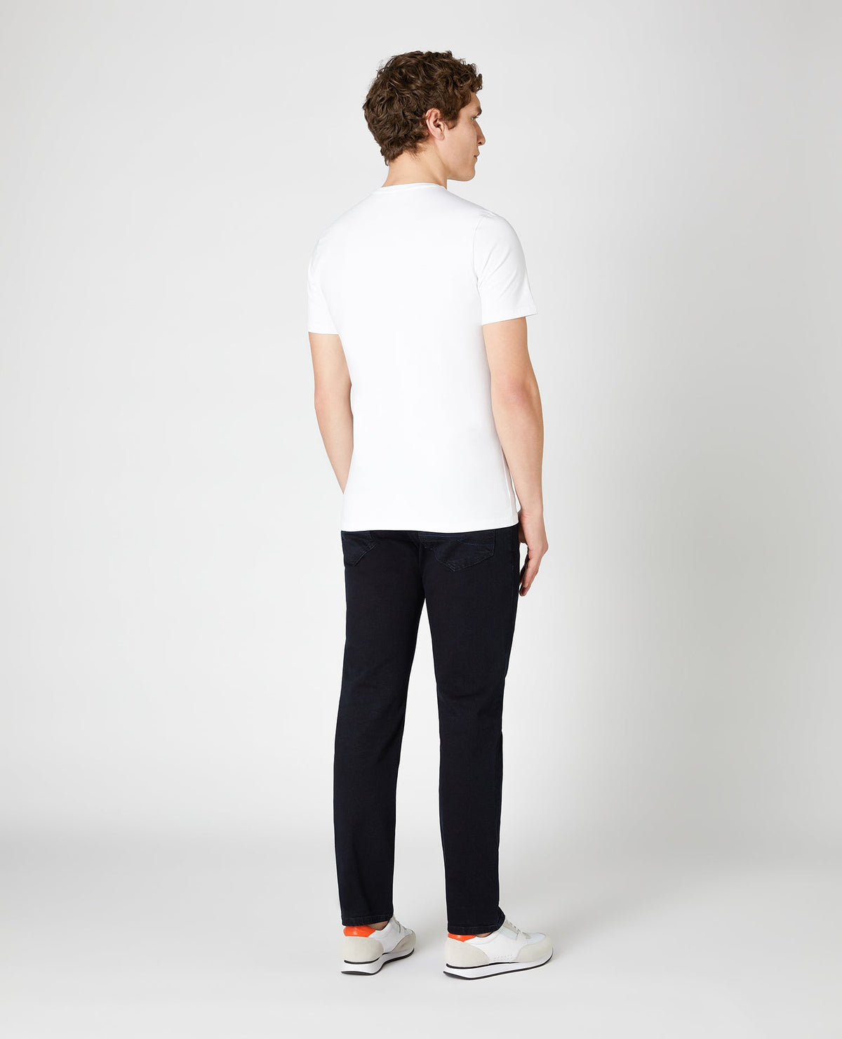 Man wearing a navy Rolston Straight Leg Cotton Stretch Jeans