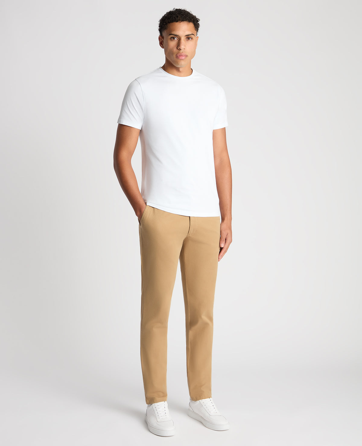 Man wearing a sand Slim Fit Cotton-Stretch Washed Chino