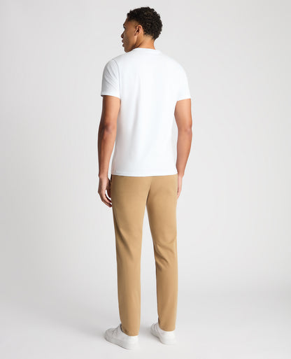Man wearing a sand Slim Fit Cotton-Stretch Washed Chino