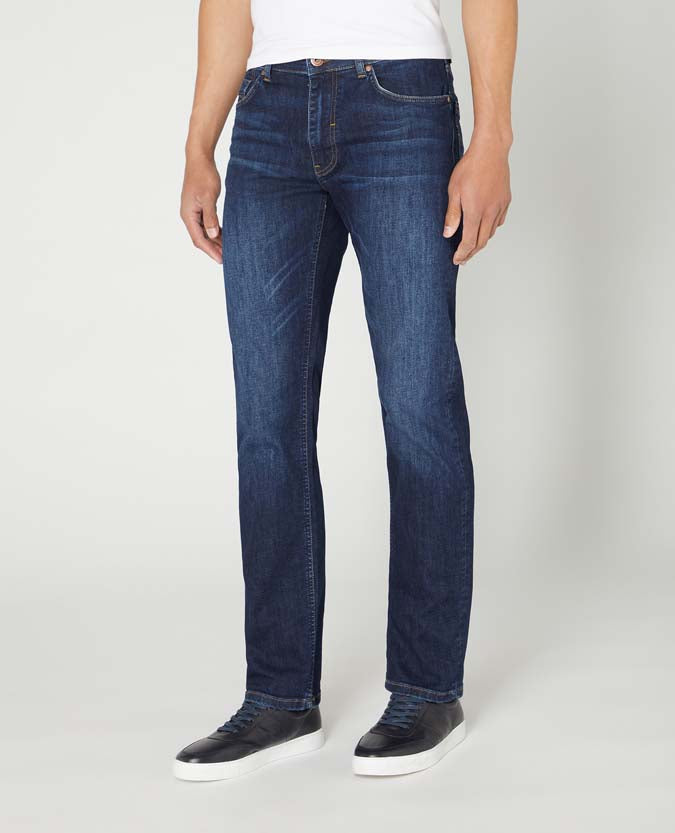 Man wearing a navy Rogan Straight Leg Cotton-Stretch Jean