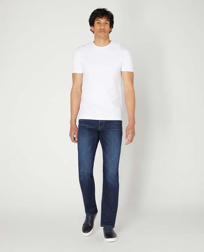 Man wearing a navy Rogan Straight Leg Cotton-Stretch Jean