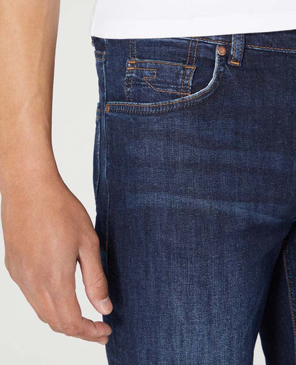 Man wearing a navy Rogan Straight Leg Cotton-Stretch Jean