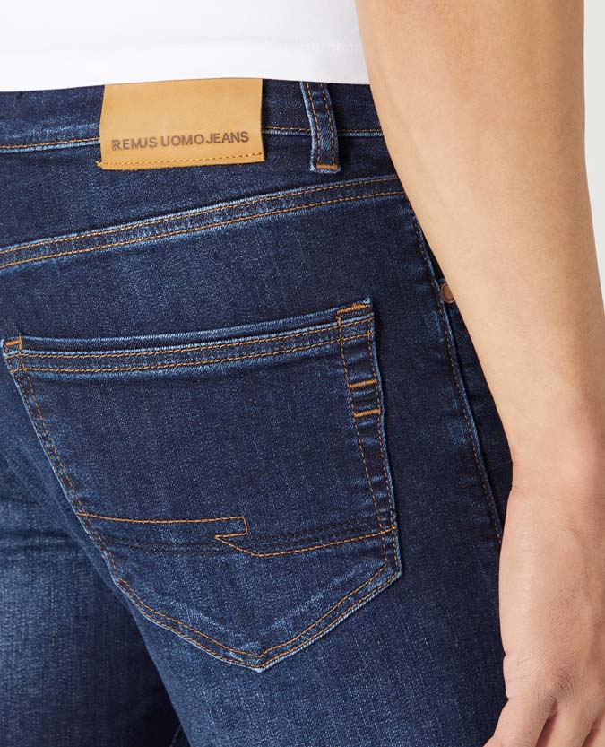 Man wearing a navy Rogan Straight Leg Cotton-Stretch Jean