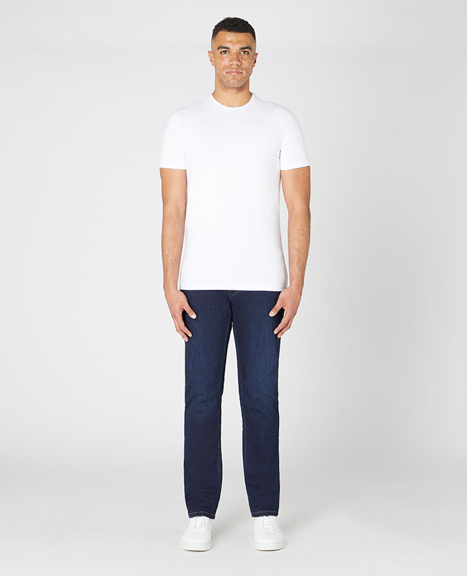 Man wearing a navy Rogan Straight Leg Cotton Power Stretch Jeans