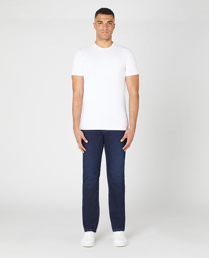 Man wearing a navy Rogan Straight Leg Cotton Power Stretch Jeans