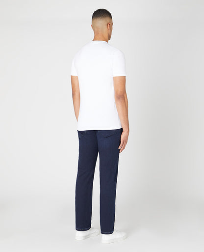Man wearing a navy Rogan Straight Leg Cotton Power Stretch Jeans
