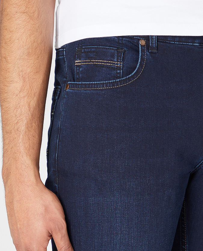 Man wearing a navy Rogan Straight Leg Cotton Power Stretch Jeans