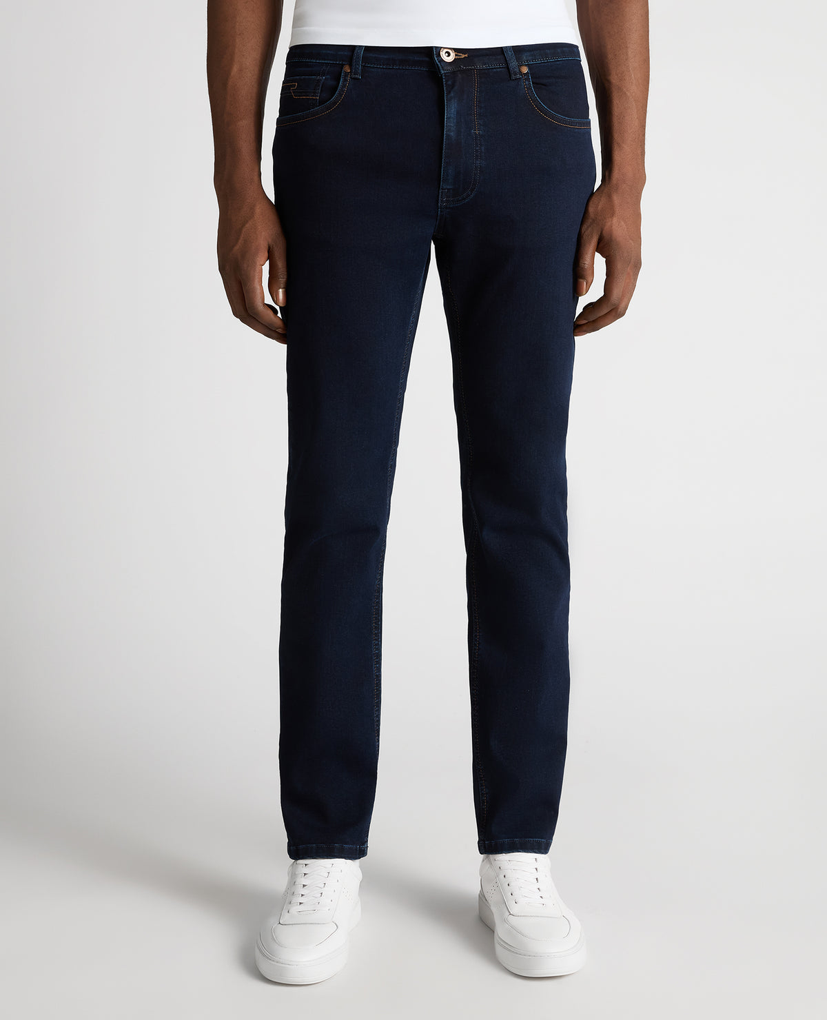 Man wearing a navy Rogan Straight Leg Cotton Power Stretch Jeans