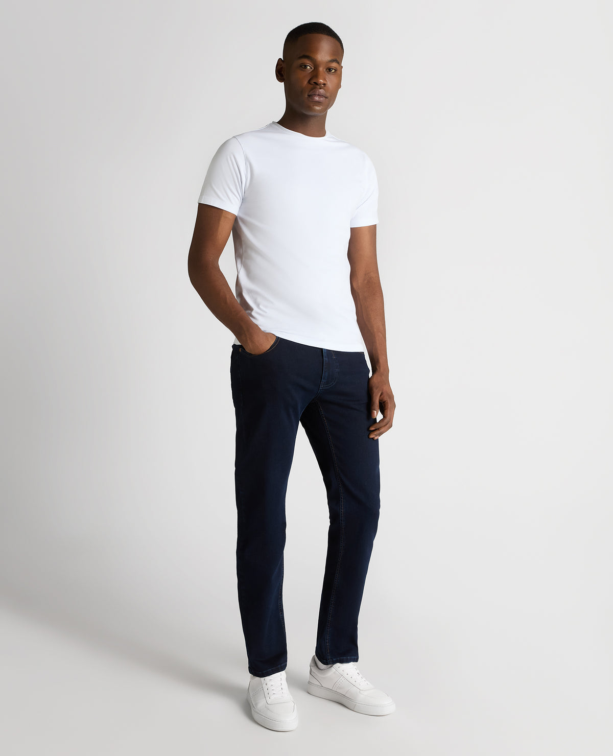 Man wearing a navy Rogan Straight Leg Cotton Power Stretch Jeans