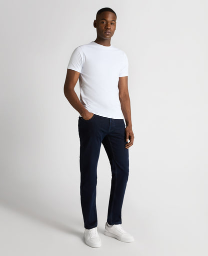 Man wearing a navy Rogan Straight Leg Cotton Power Stretch Jeans