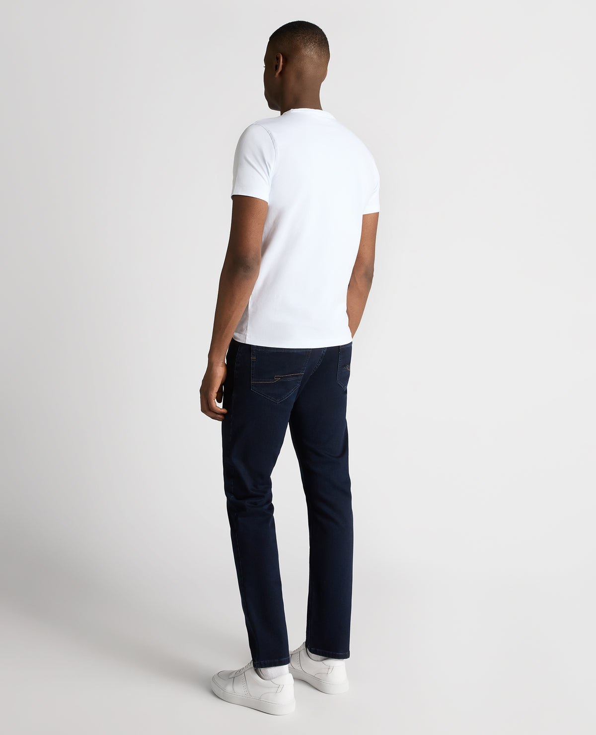 Man wearing a navy Rogan Straight Leg Cotton Power Stretch Jeans