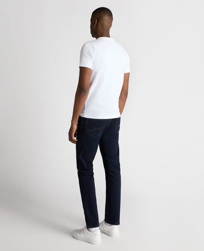 Man wearing a navy Rogan Straight Leg Cotton Power Stretch Jeans