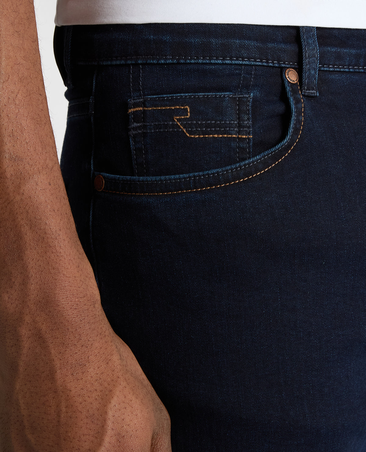 Man wearing a navy Rogan Straight Leg Cotton Power Stretch Jeans