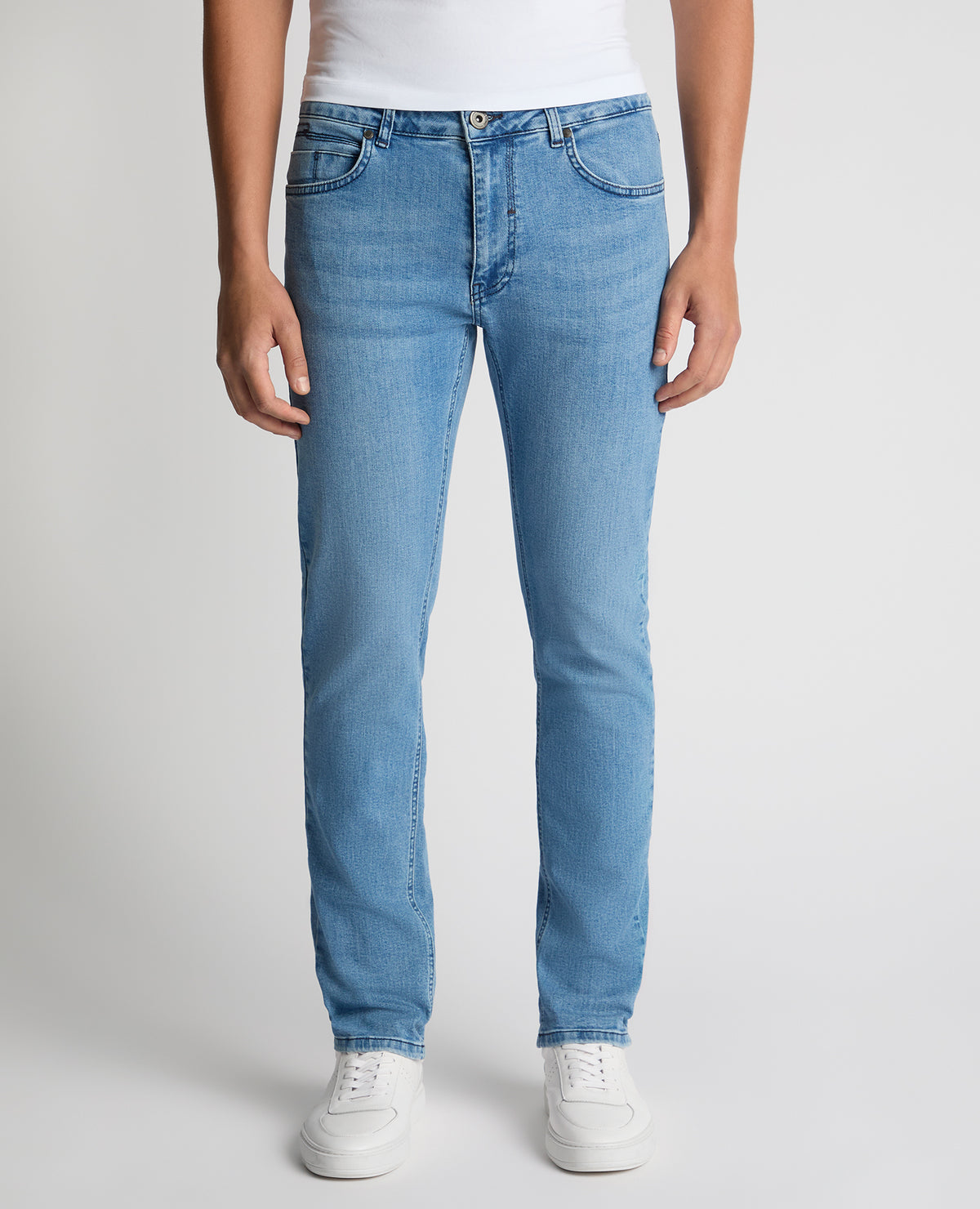 Man wearing a blue Apollo Slim Leg Cotton Power Stretch Jeans