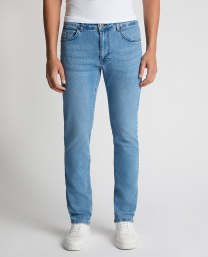 Man wearing a blue Apollo Slim Leg Cotton Power Stretch Jeans