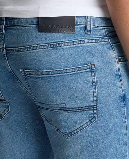 Man wearing a blue Apollo Slim Leg Cotton Power Stretch Jeans