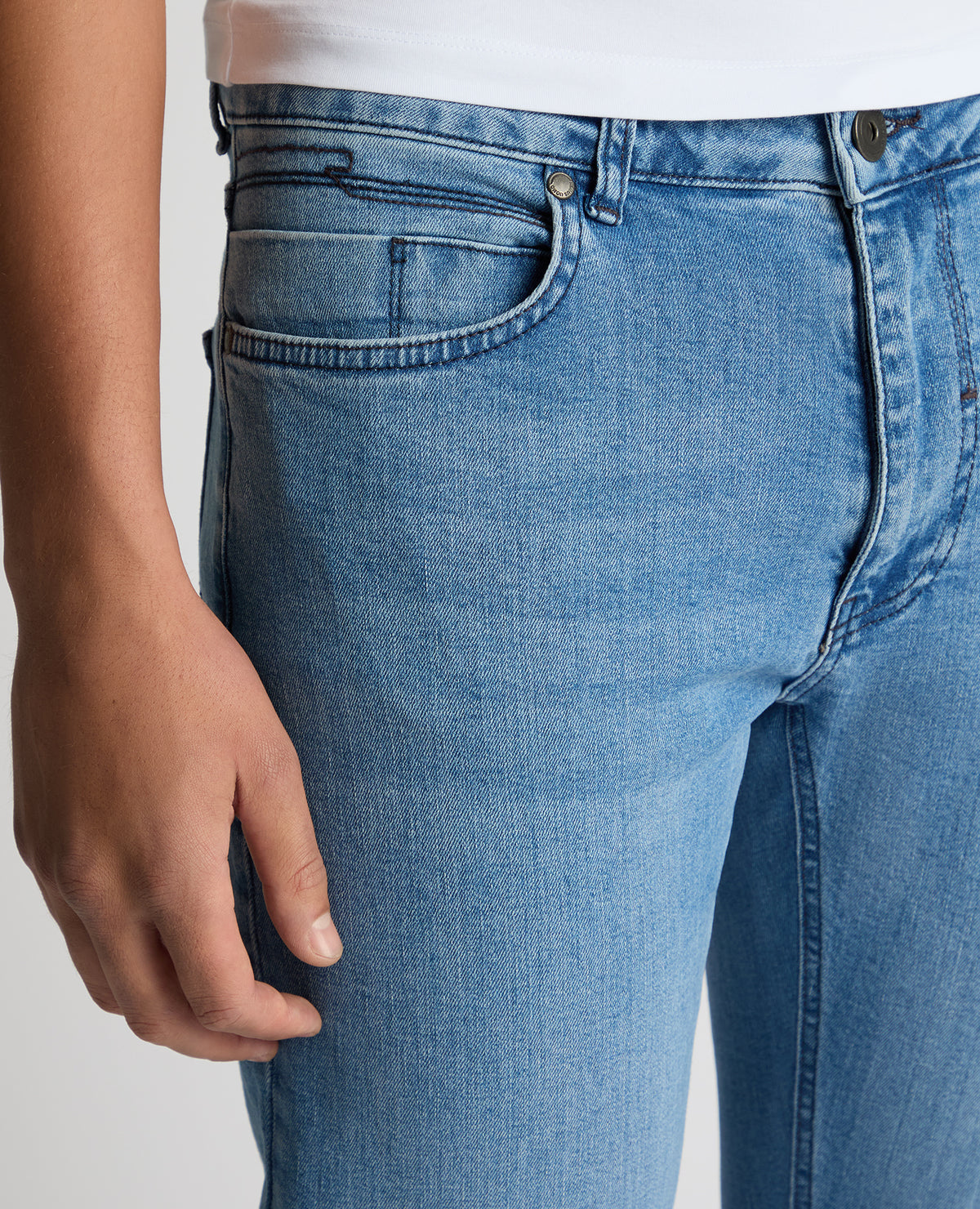 Man wearing a blue Apollo Slim Leg Cotton Power Stretch Jeans