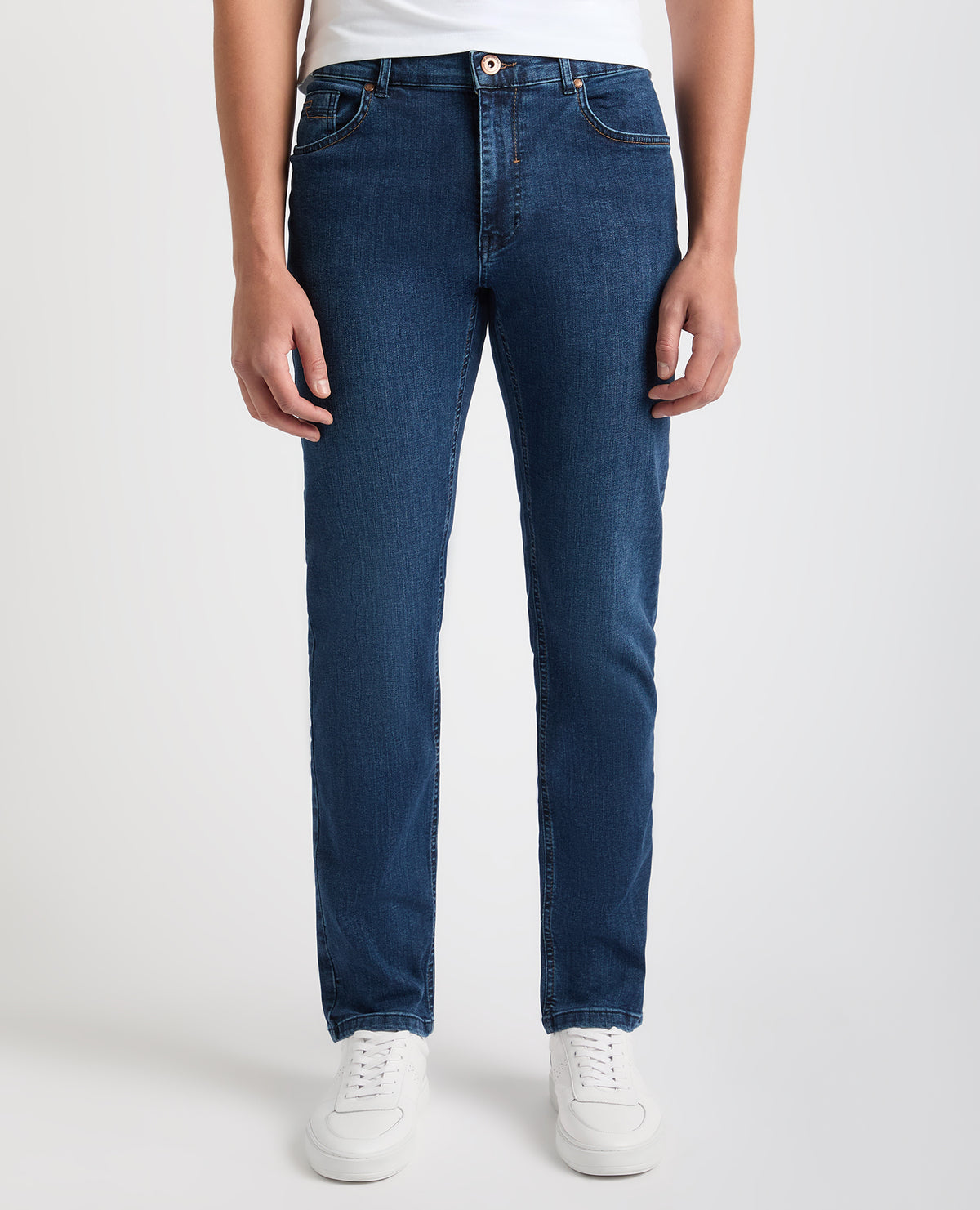 Man wearing a blue Apollo Slim Leg Cotton Power Stretch Jeans
