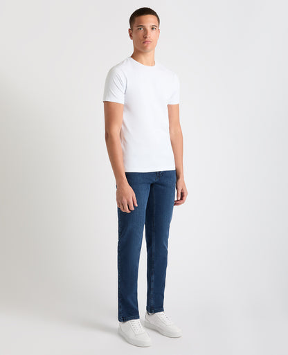 Man wearing a blue Apollo Slim Leg Cotton Power Stretch Jeans