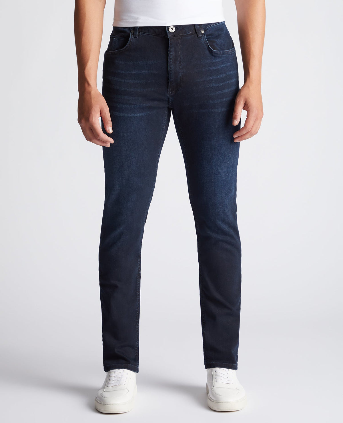 Man wearing a navy Apollo Slim Leg Cotton Power Stretch Jeans