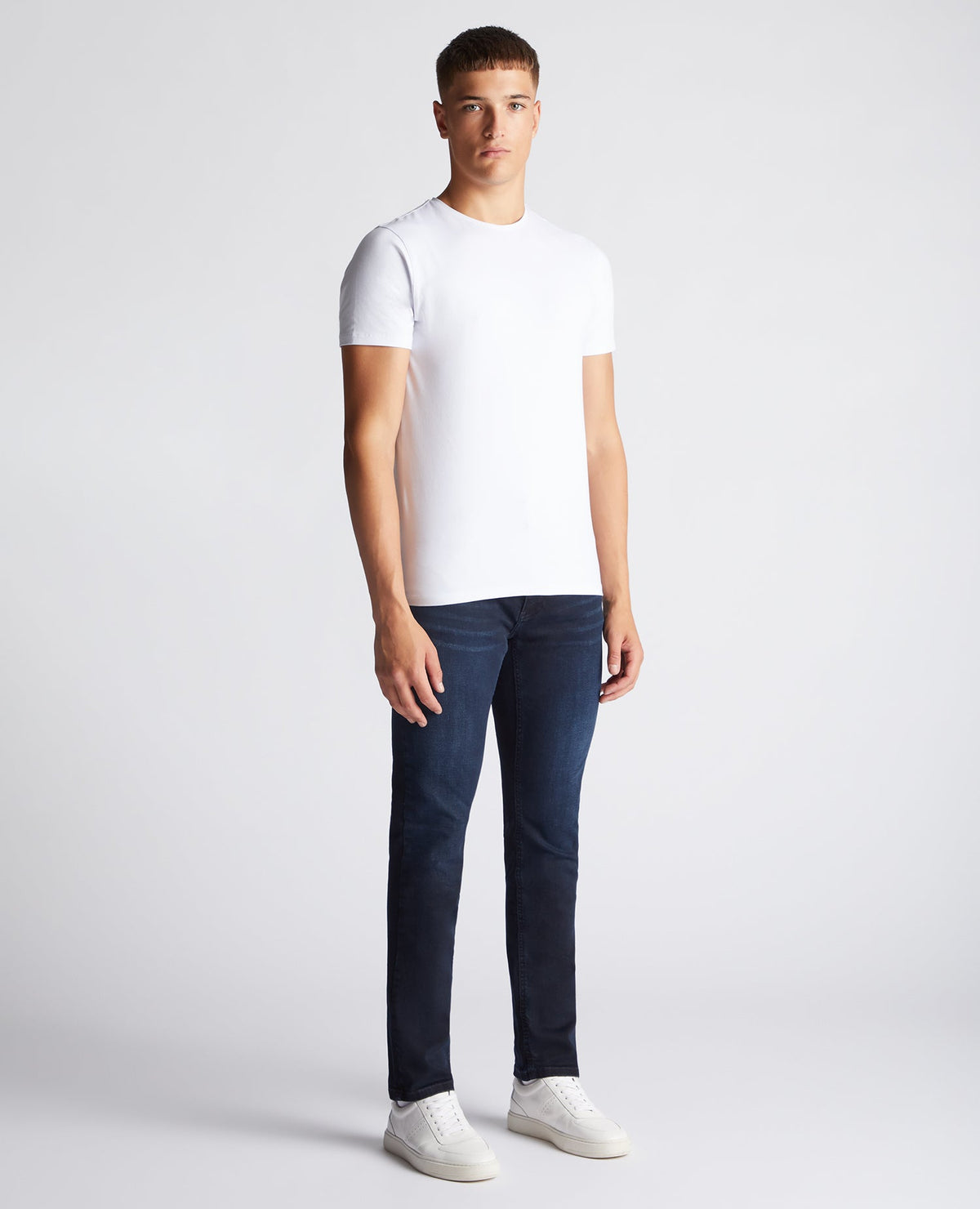 Man wearing a navy Apollo Slim Leg Cotton Power Stretch Jeans