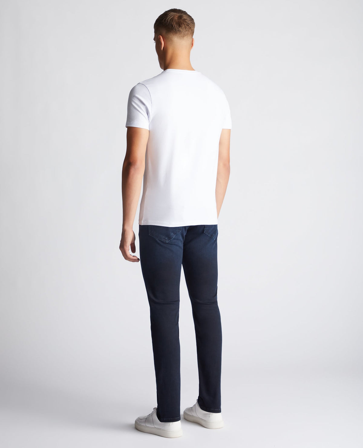 Man wearing a navy Apollo Slim Leg Cotton Power Stretch Jeans