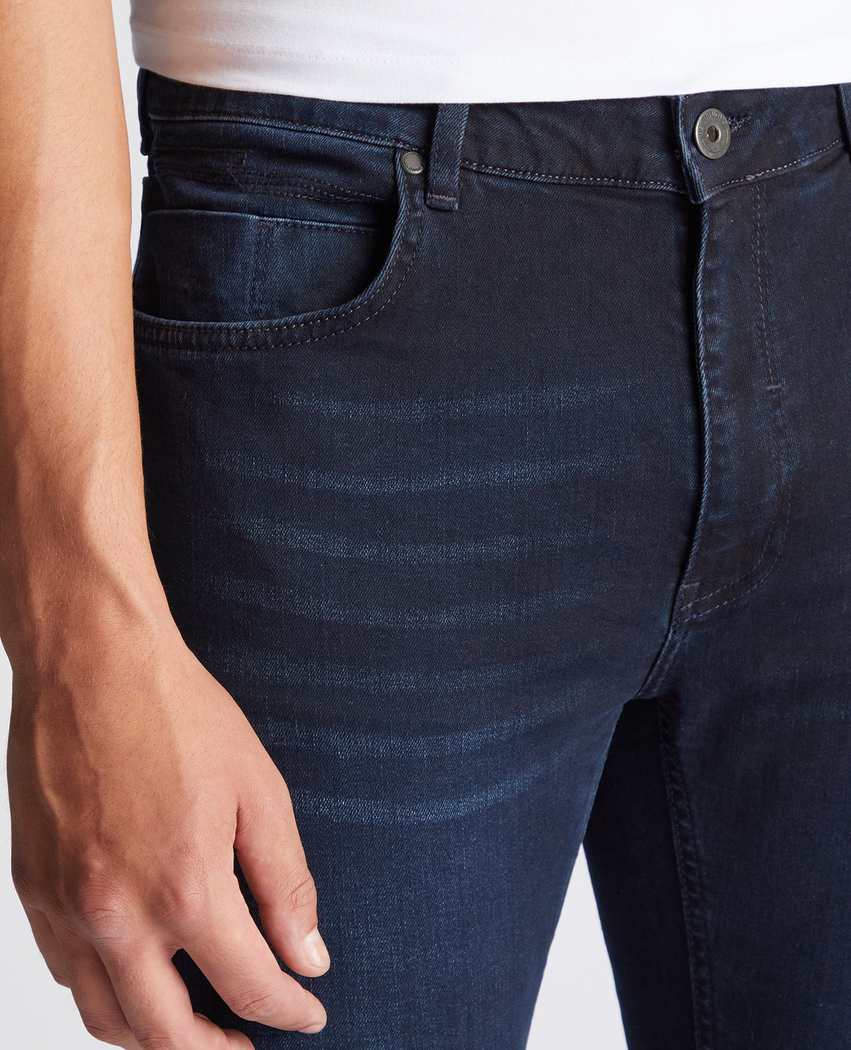 Man wearing a navy Apollo Slim Leg Cotton Power Stretch Jeans