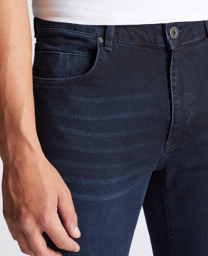 Man wearing a navy Apollo Slim Leg Cotton Power Stretch Jeans