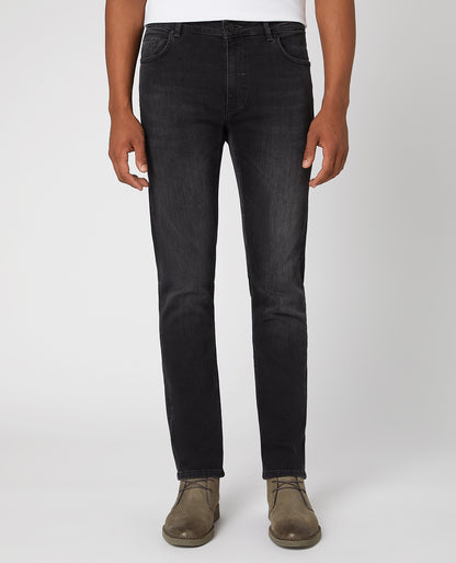 Man wearing a grey Apollo Slim Leg Cotton Power Stretch Jeans