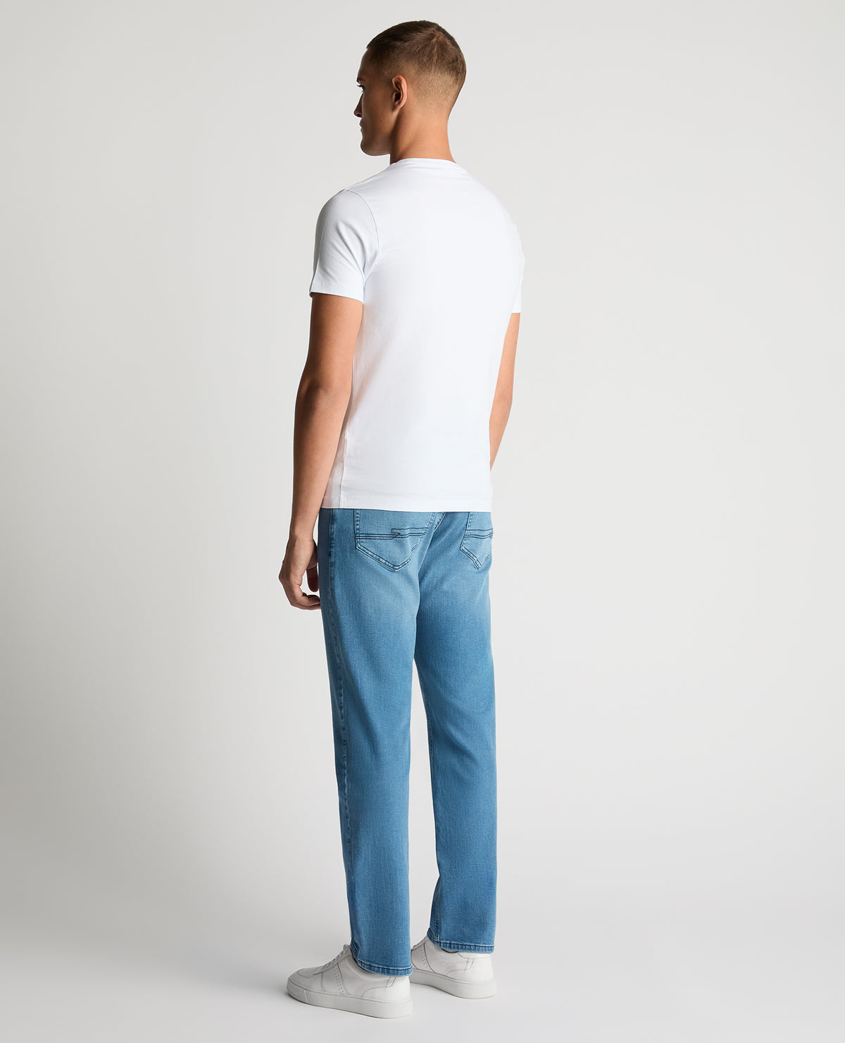 Man wearing a blue Rogan Straight Leg Eco Cotton-Stretch Jeans