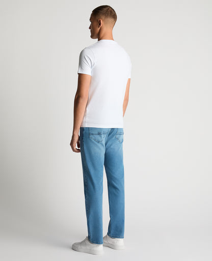 Man wearing a blue Rogan Straight Leg Eco Cotton-Stretch Jeans