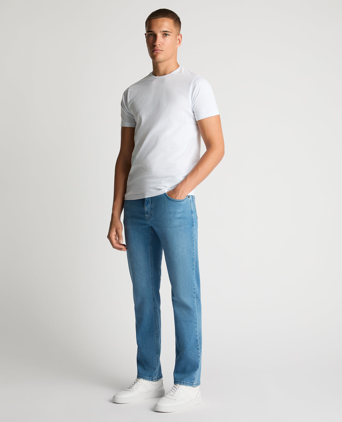 Man wearing a blue Rogan Straight Leg Eco Cotton-Stretch Jeans