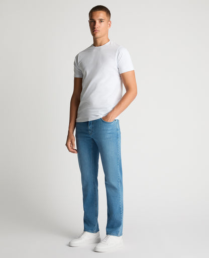 Man wearing a blue Rogan Straight Leg Eco Cotton-Stretch Jeans