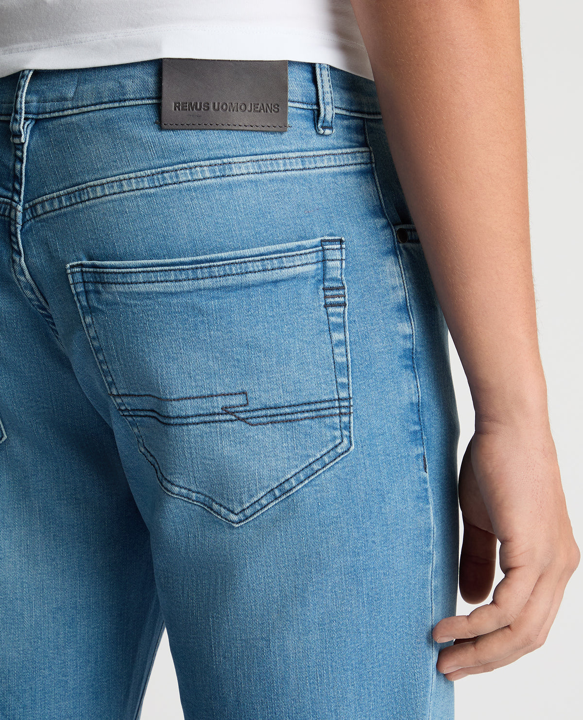 Man wearing a blue Rogan Straight Leg Eco Cotton-Stretch Jeans