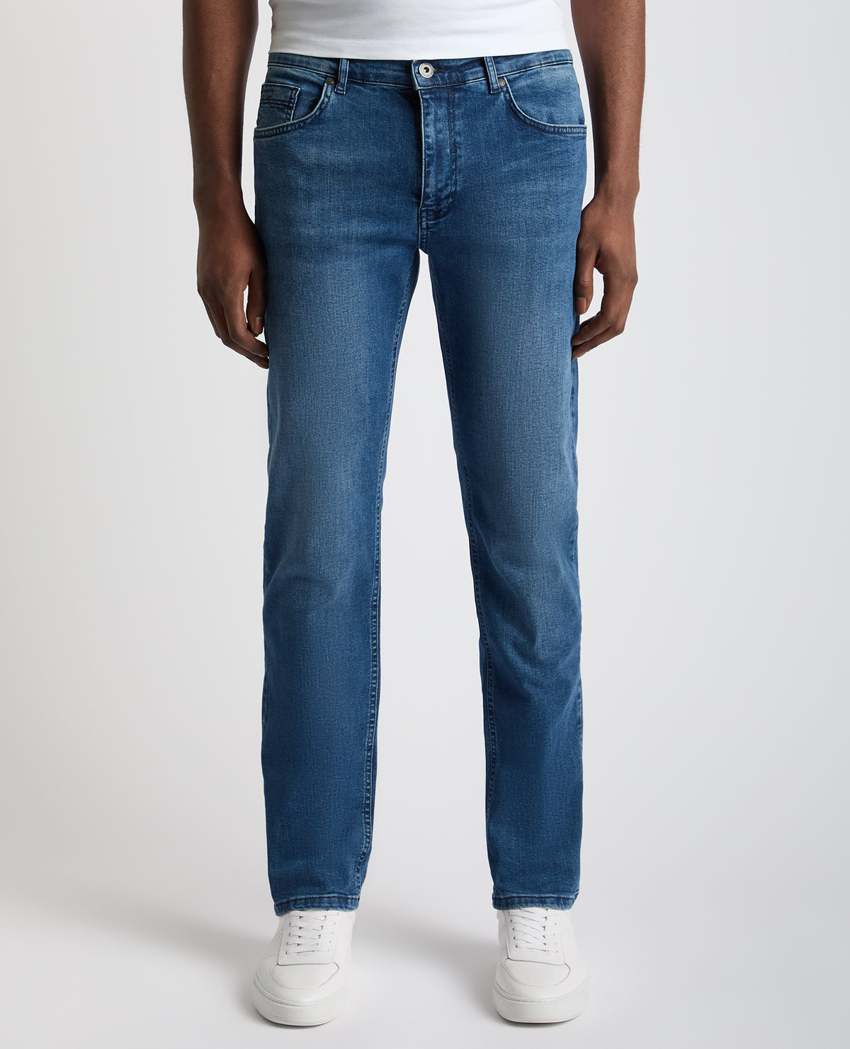 Man wearing a blue Rogan Straight Leg Eco Cotton-Stretch Jeans