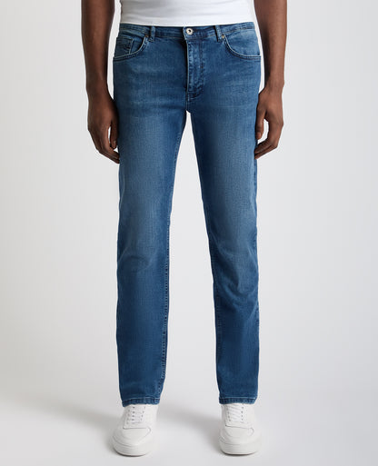 Man wearing a blue Rogan Straight Leg Eco Cotton-Stretch Jeans