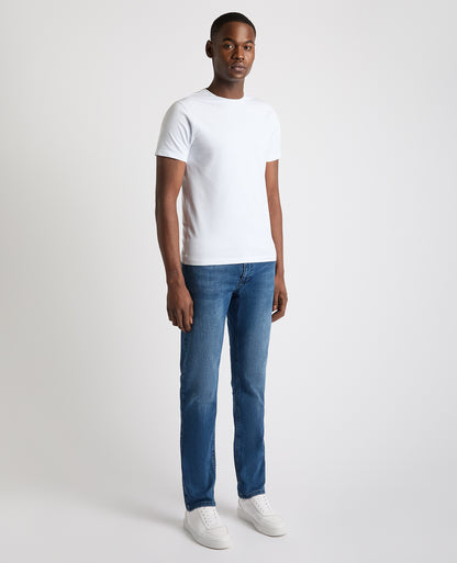Man wearing a blue Rogan Straight Leg Eco Cotton-Stretch Jeans