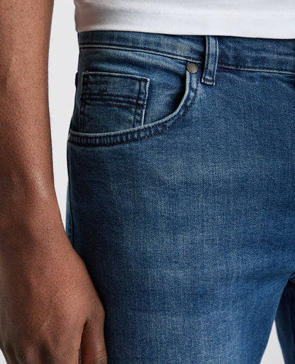 Man wearing a blue Rogan Straight Leg Eco Cotton-Stretch Jeans