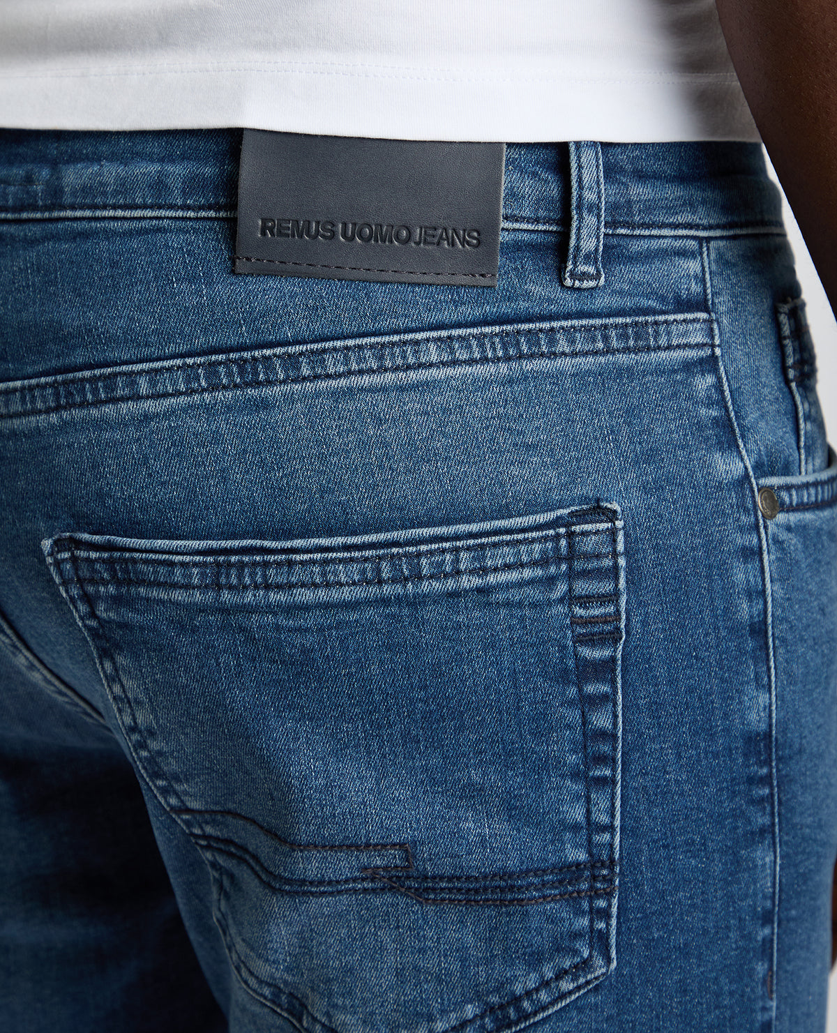 Man wearing a blue Rogan Straight Leg Eco Cotton-Stretch Jeans
