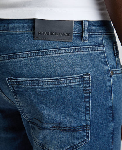 Man wearing a blue Rogan Straight Leg Eco Cotton-Stretch Jeans