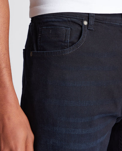 Man wearing a navy Rogan Straight Leg Eco Cotton-Stretch Jeans