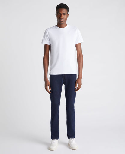 Man wearing a navy Slim Leg Comfort Stretch Jean