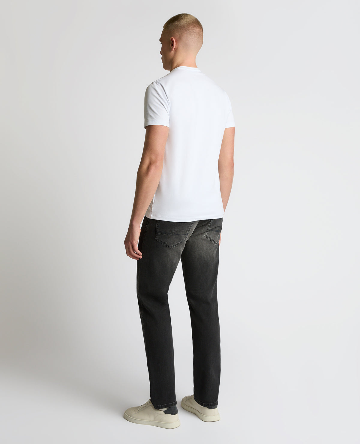 Man wearing a grey Rogan Dark Wash Straight Leg Jeans