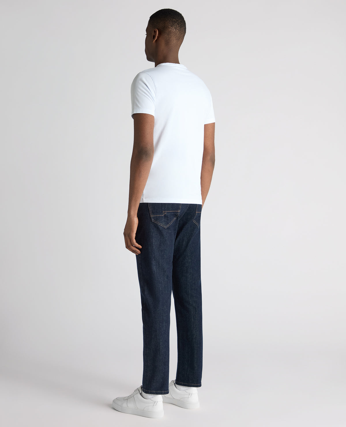 Man wearing a navy Roman Modern Straight Leg Jeans
