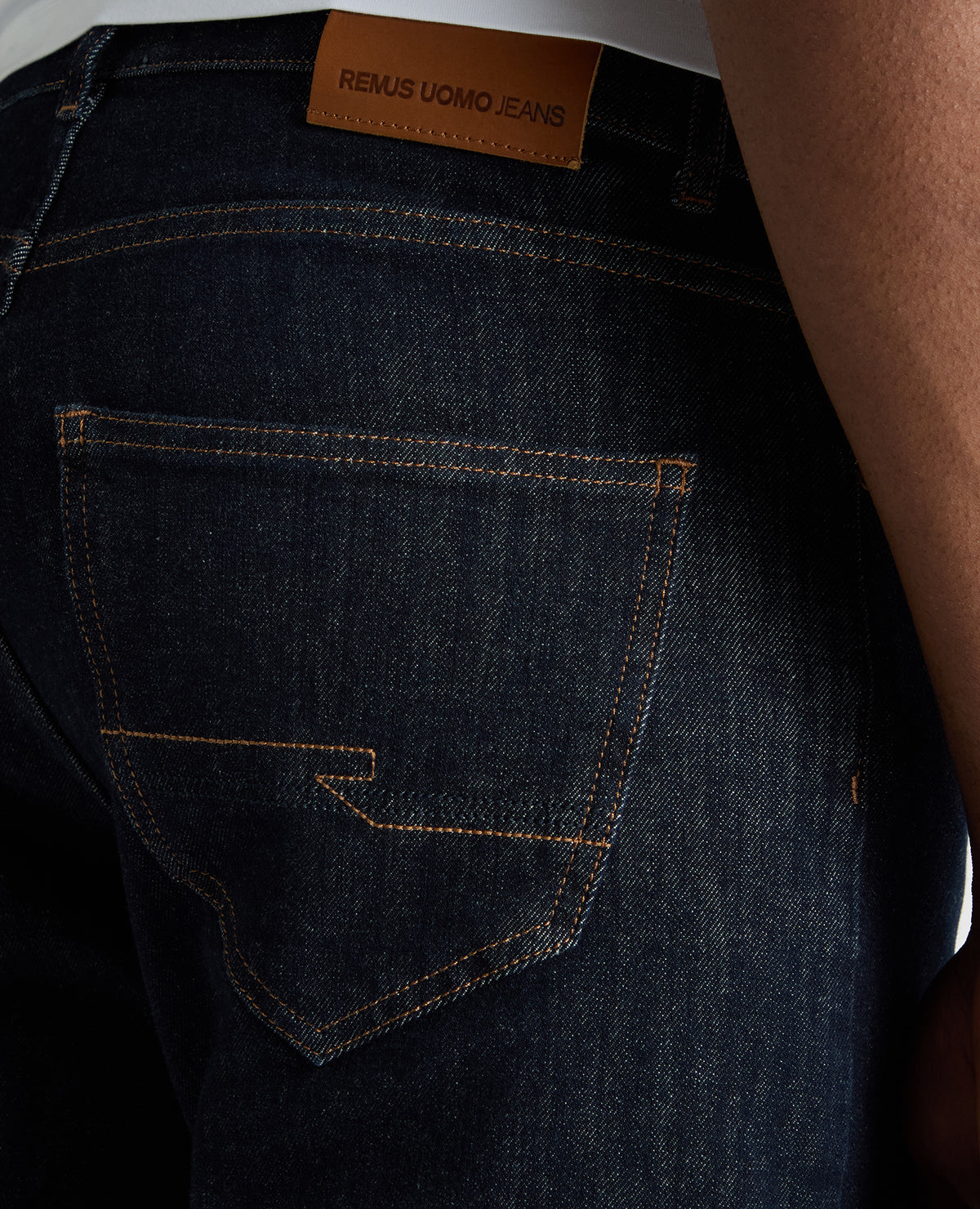 Man wearing a navy Roman Modern Straight Leg Jeans
