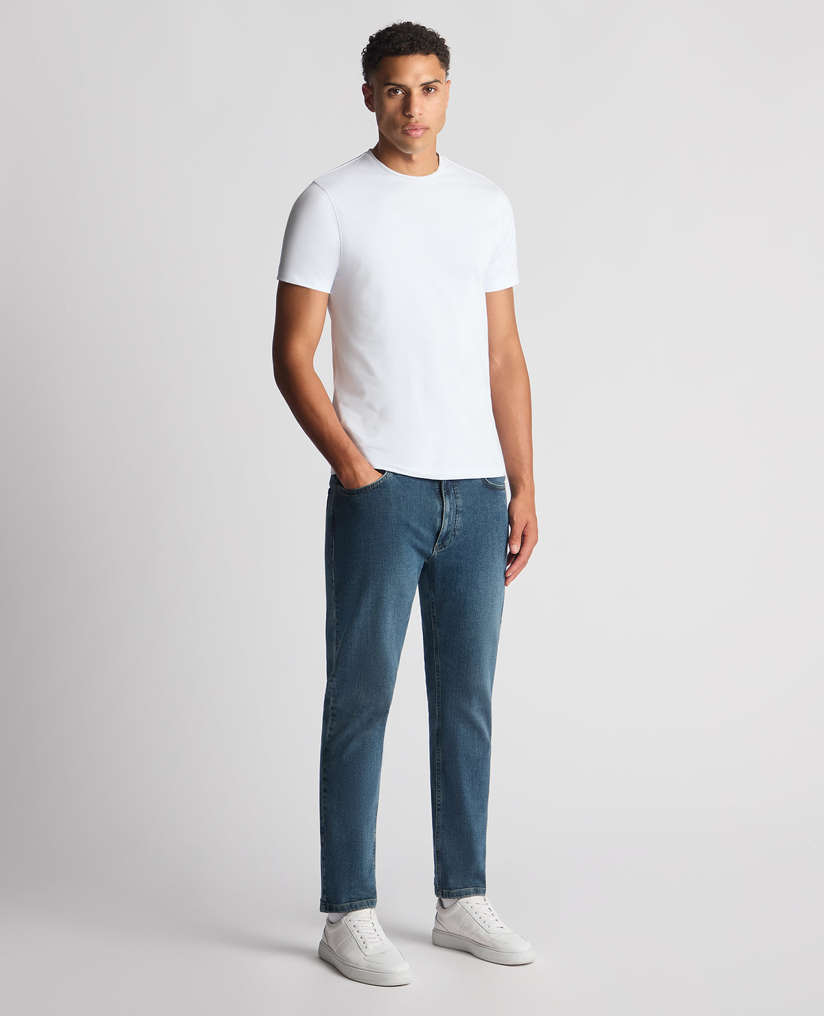 Man wearing a blue Roman Modern Straight Fit Cotton-Stretch Jean